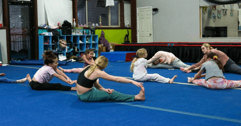 Children stretching during gymnastics class at FlipZone Gymnastics Center in Lee’s Summit, MO