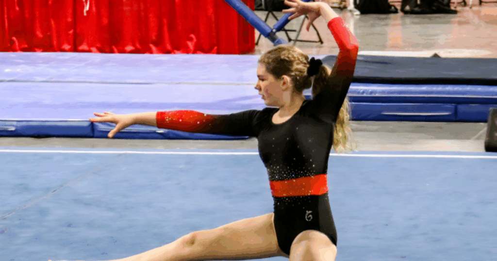 FlipZone gymnast performing a floor routine with strong flexibility and control at a gymnastics competition in Lee’s Summit due to low student to teacher ratios