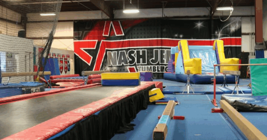 Gymnastics facility setup at FlipZone in Lee’s Summit featuring balance beams, trampolines, and tumbling equipment used for children’s recreational and a competitive training experience.