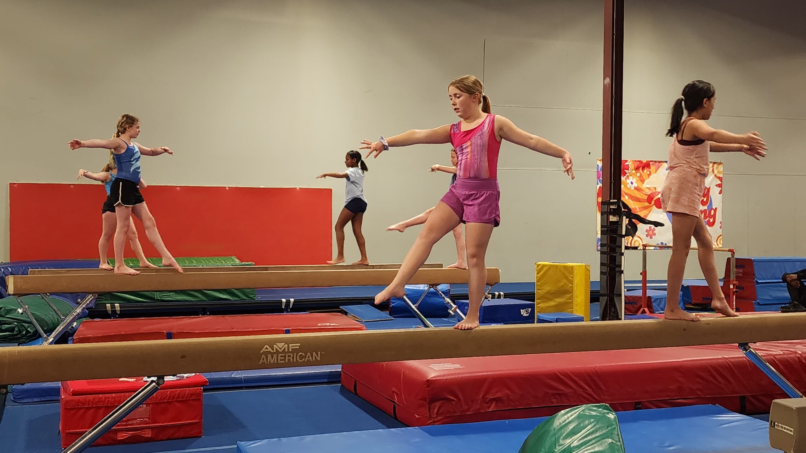 Kids practicing balance beam gymnastics at FlipZone in Lee’s Summit to build coordination, confidence, and strength